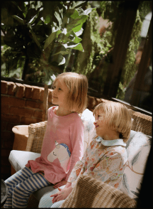two girls sitting on a chair