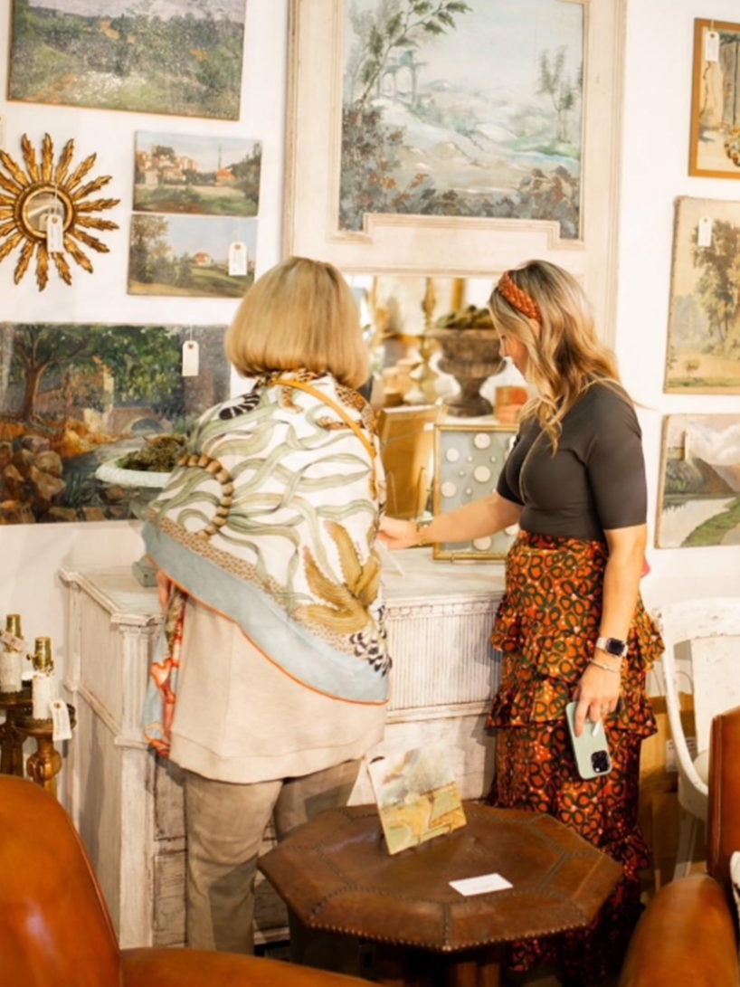 Woman holding a wine glass and looking at a jewelry display
